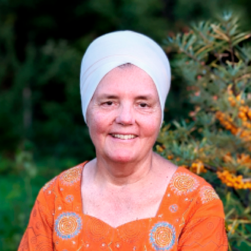 Sat Dharam Kaur Smiling in an orchard