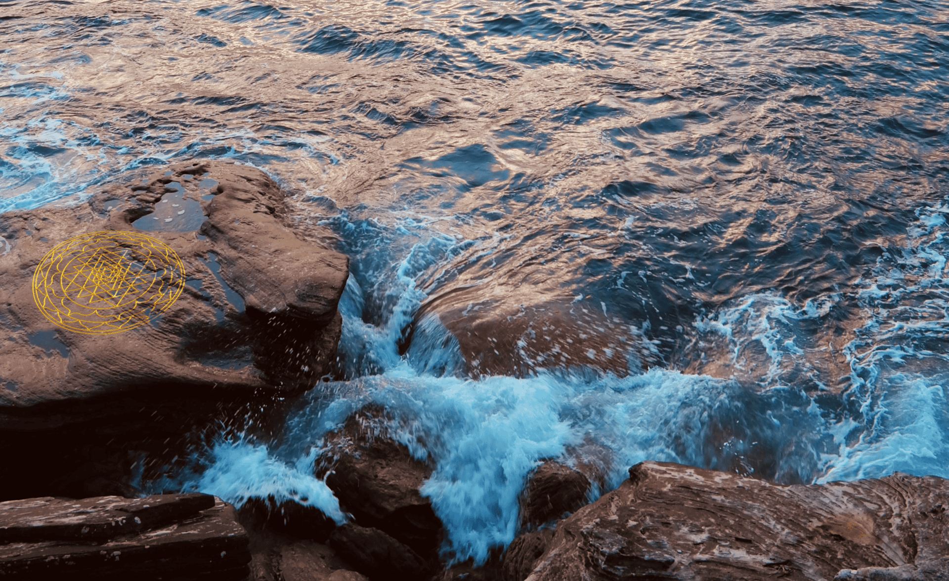 pexels-katebranch-8826913-beveled a sri yantra mandala is visible on one of the rocks as waves break on them